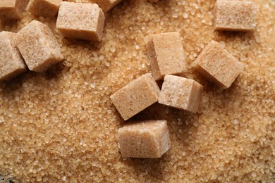 Photo of Different types of brown sugar as background, top view