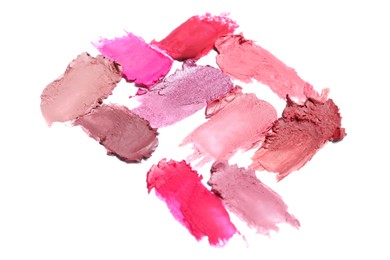 Photo of Smears of different bright lipsticks on white background