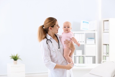 Children's doctor with cute baby in hospital