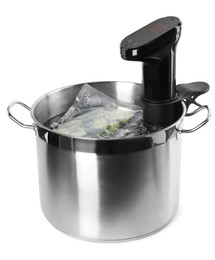 Photo of Thermal immersion circulator and vacuum packed broccoli in pot on white background. Sous vide cooking