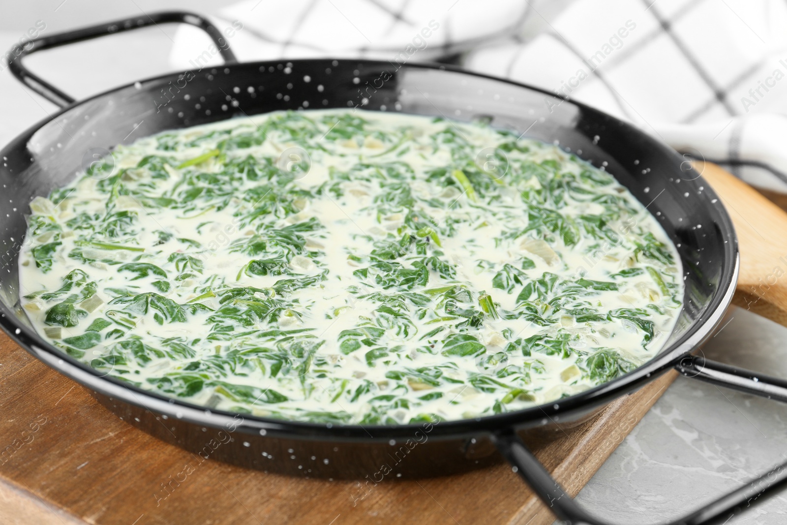 Photo of Tasty spinach dip on grey marble table