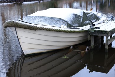 Water canal with moored boat on winter day