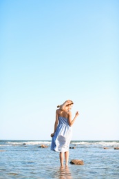 Photo of Young woman enjoying sunny day on beach