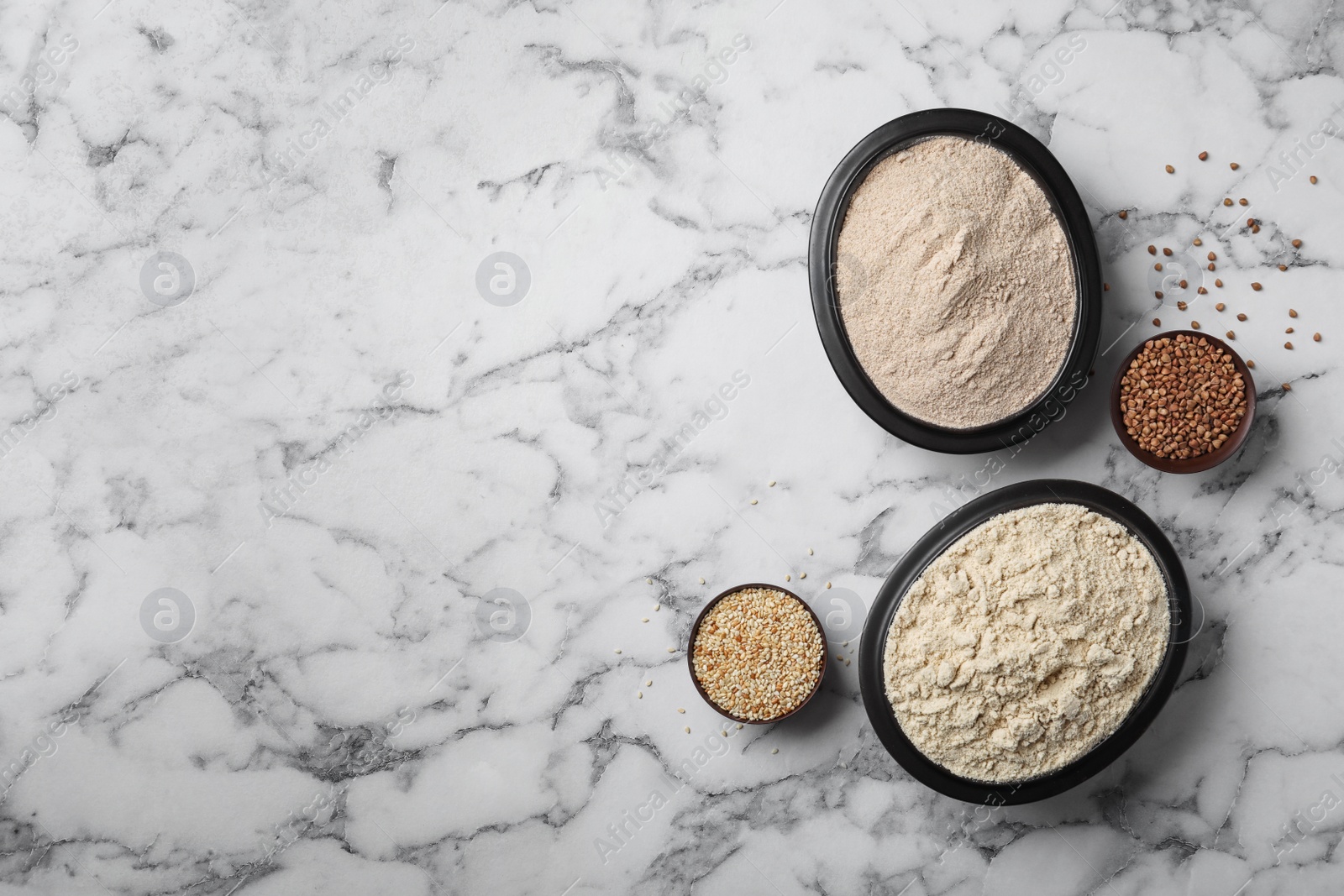 Photo of Composition with different types of flour on marble background