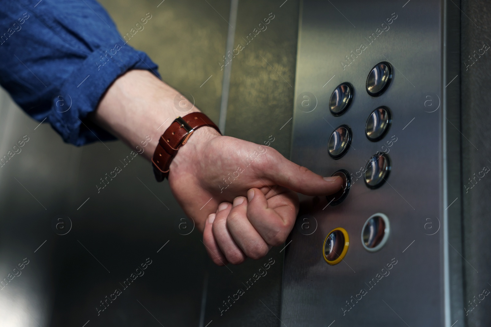 Photo of Man choosing floor in elevator, closeup view