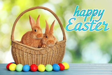 Image of Happy Easter. Adorable bunnies in wicker basket and eggs on wooden table outdoors