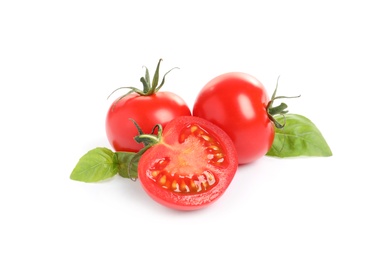 Photo of Fresh cherry tomatoes with basil isolated on white