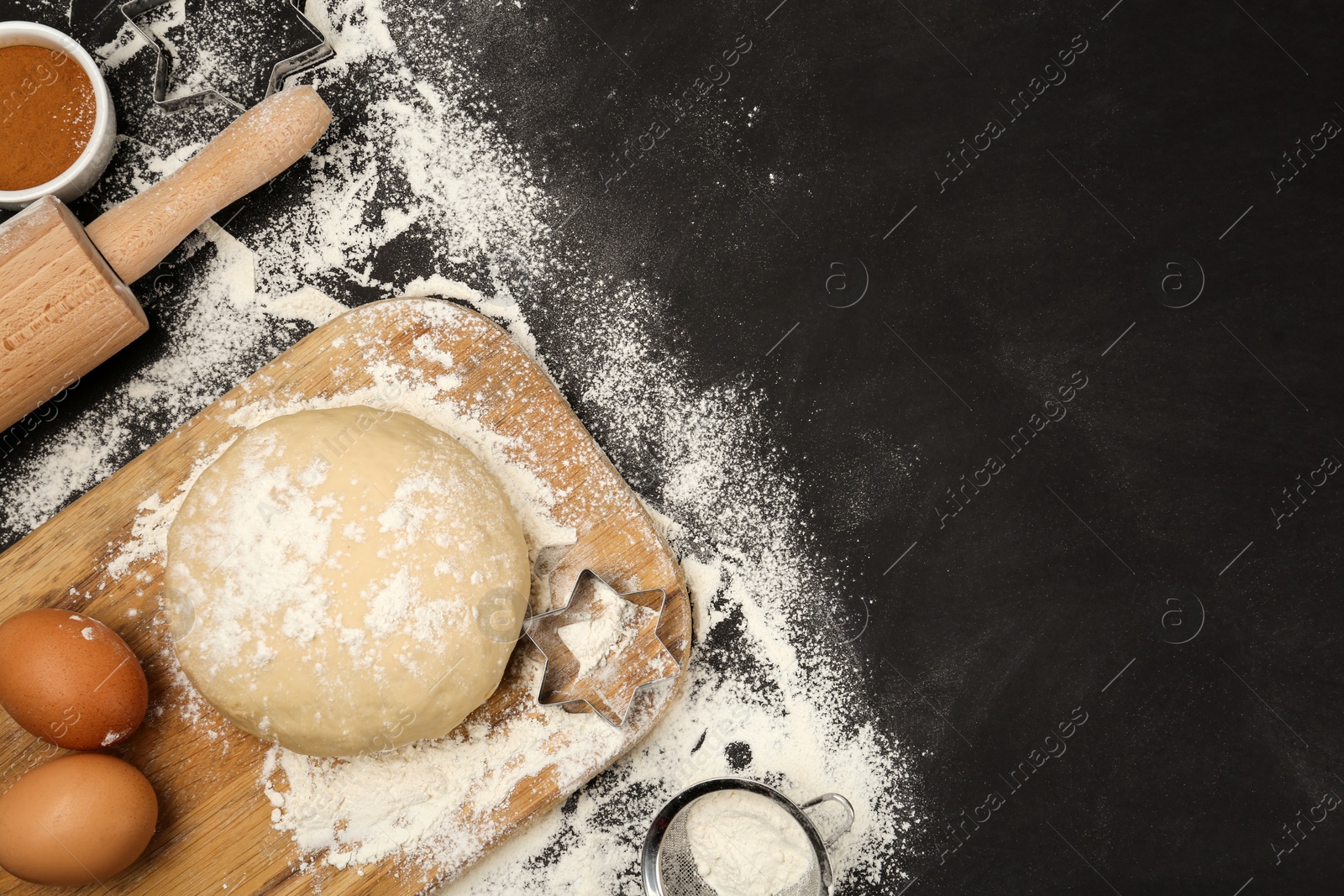 Photo of Flat lay composition with eggs and other ingredients on black table, space for text. Baking pie