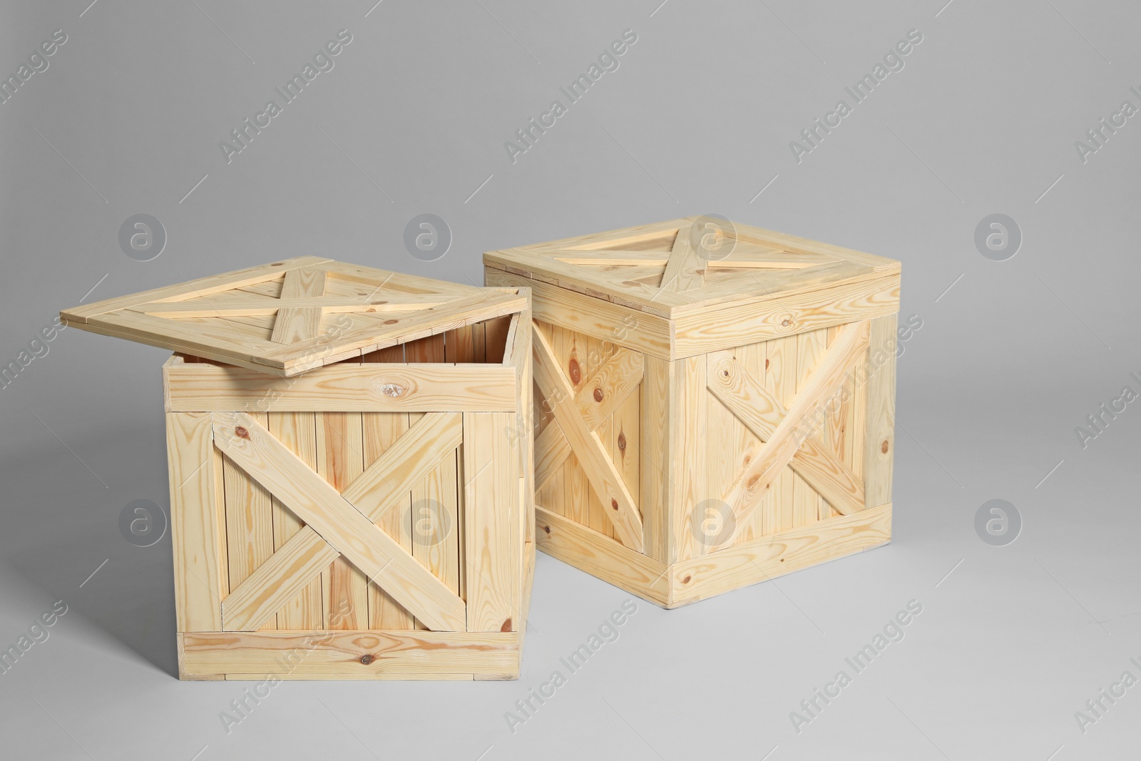 Photo of Pair of wooden crates on grey background