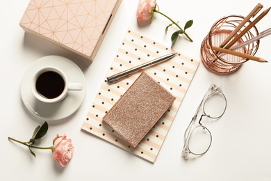 Photo of Flat lay composition with notebooks, cup of coffee and stationery on white background