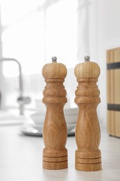 Wooden salt and pepper shakers on table in kitchen