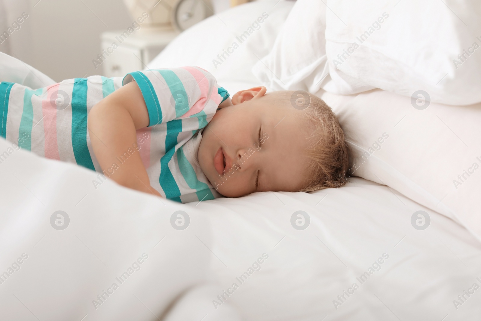 Photo of Little child sleeping in bed at home