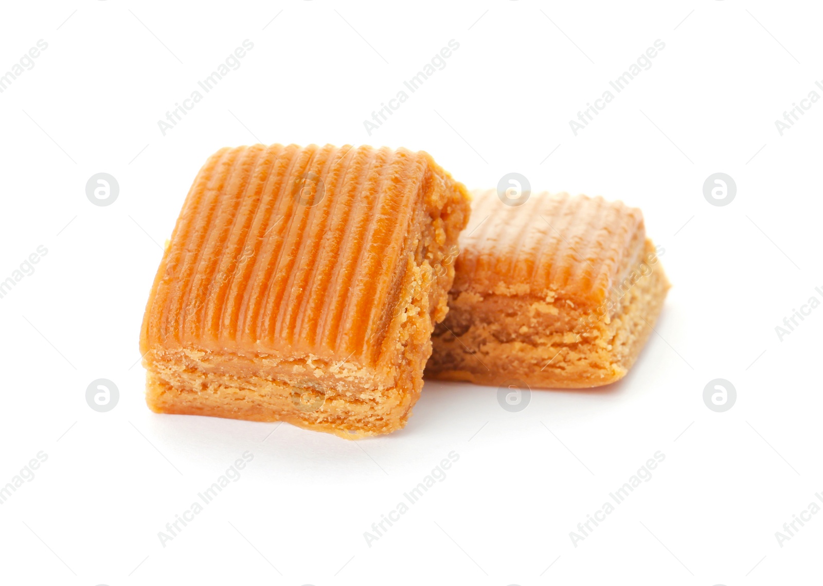 Photo of Delicious caramel candies on white background