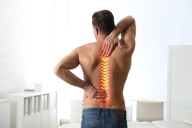 Image of Man suffering from pain in back at clinic 
