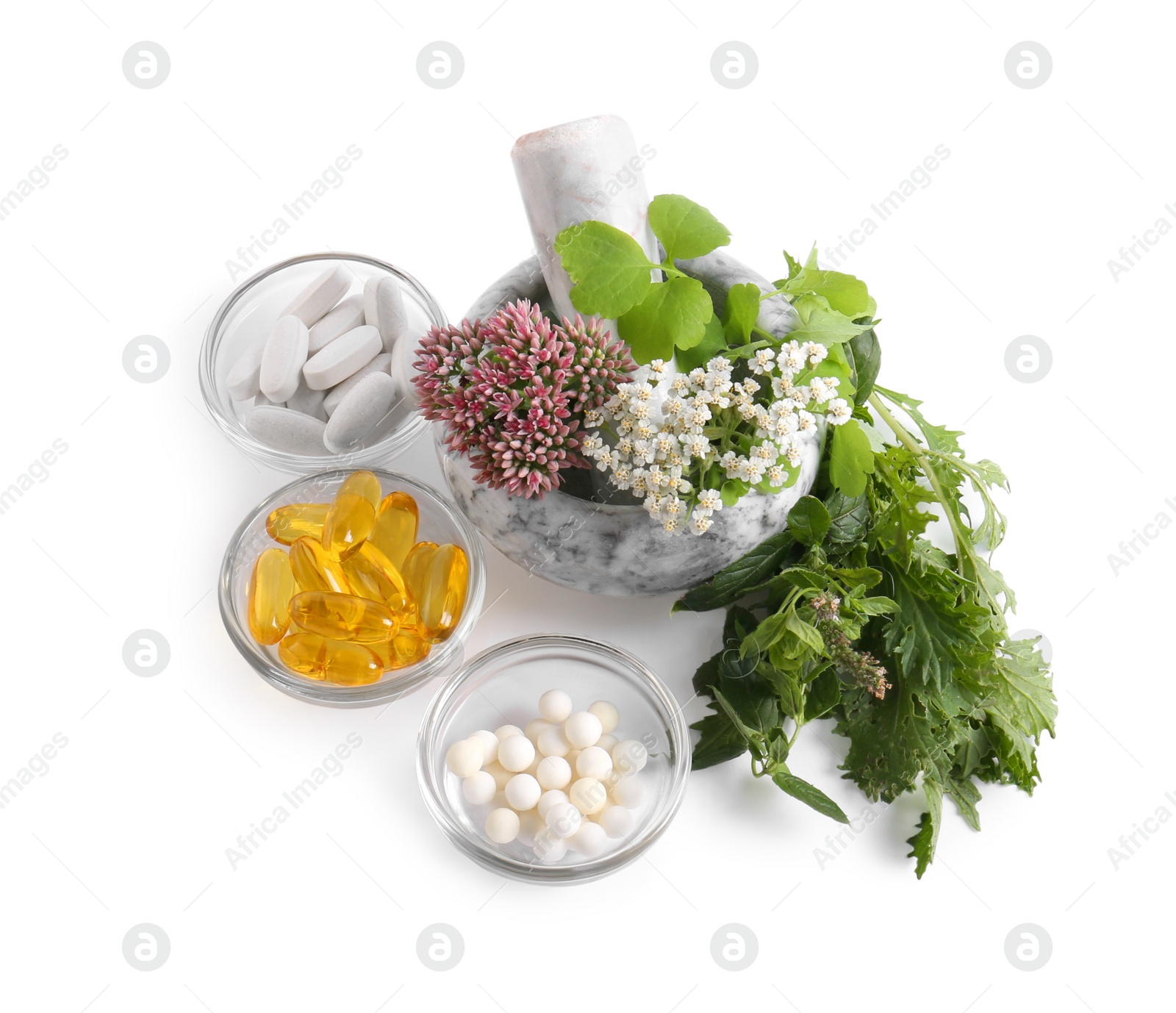 Photo of Marble mortar with fresh herbs and pills on white background