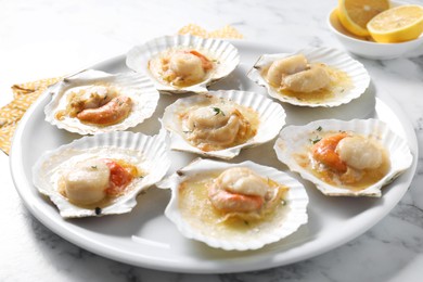 Fried scallops in shells on white marble table, closeup