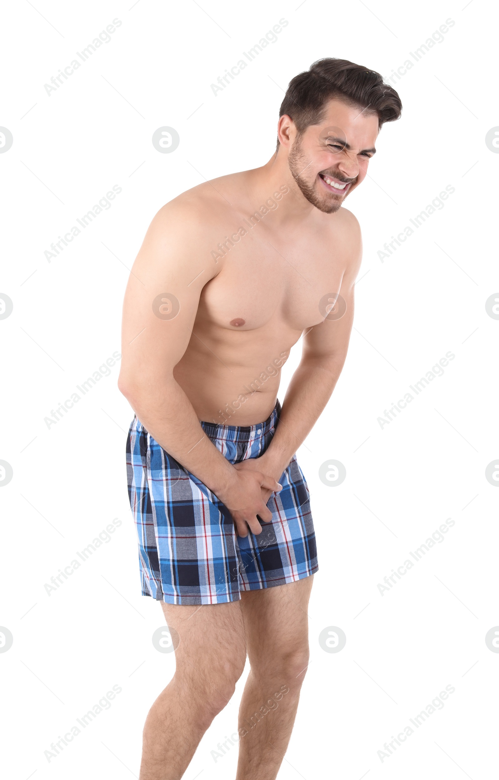 Photo of Young man with urological problems suffering from pain on white background