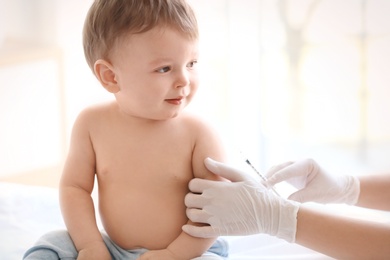 Doctor vaccinating baby in clinic