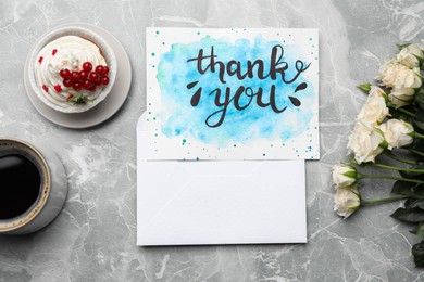 Card with phrase Thank you, cup of coffee, cupcake and flowers on light grey marble table, flat lay