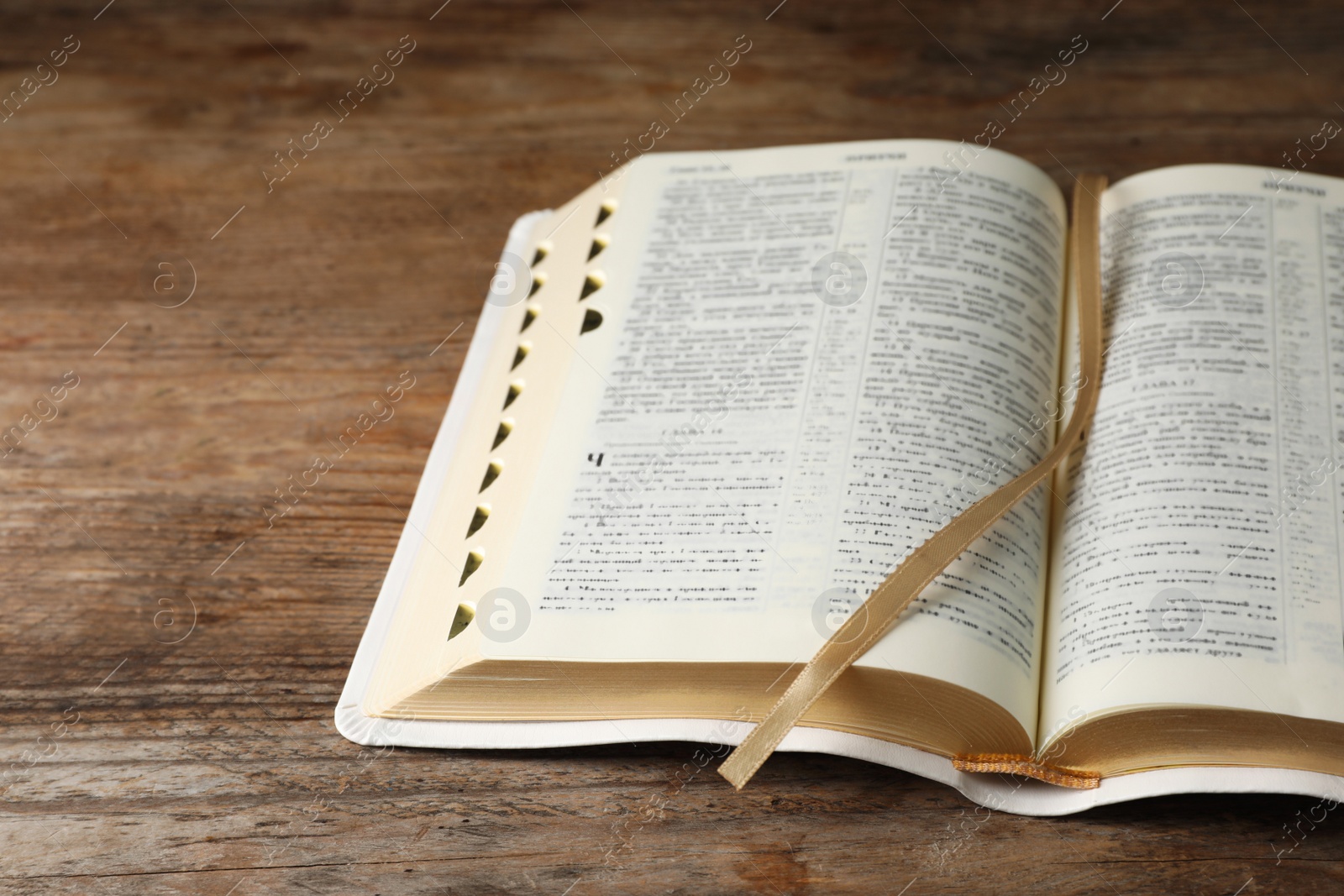Photo of Open Bible on wooden table. Christian religious book