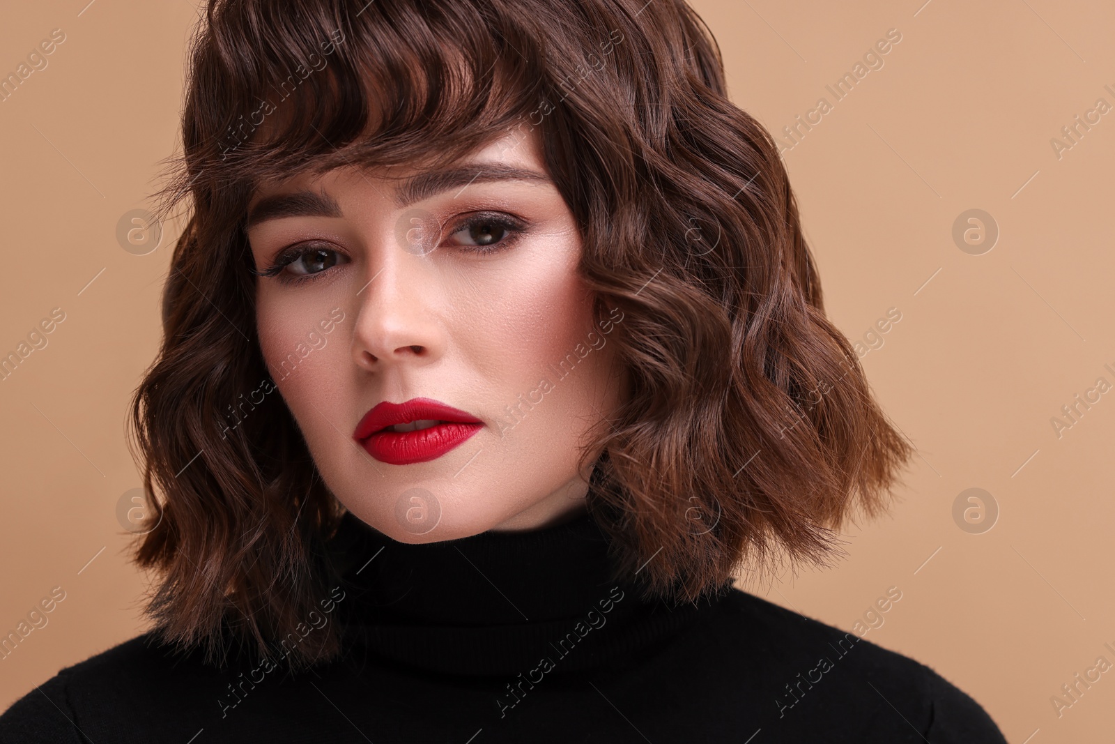 Photo of Beautiful young woman with wavy hairstyle on beige background