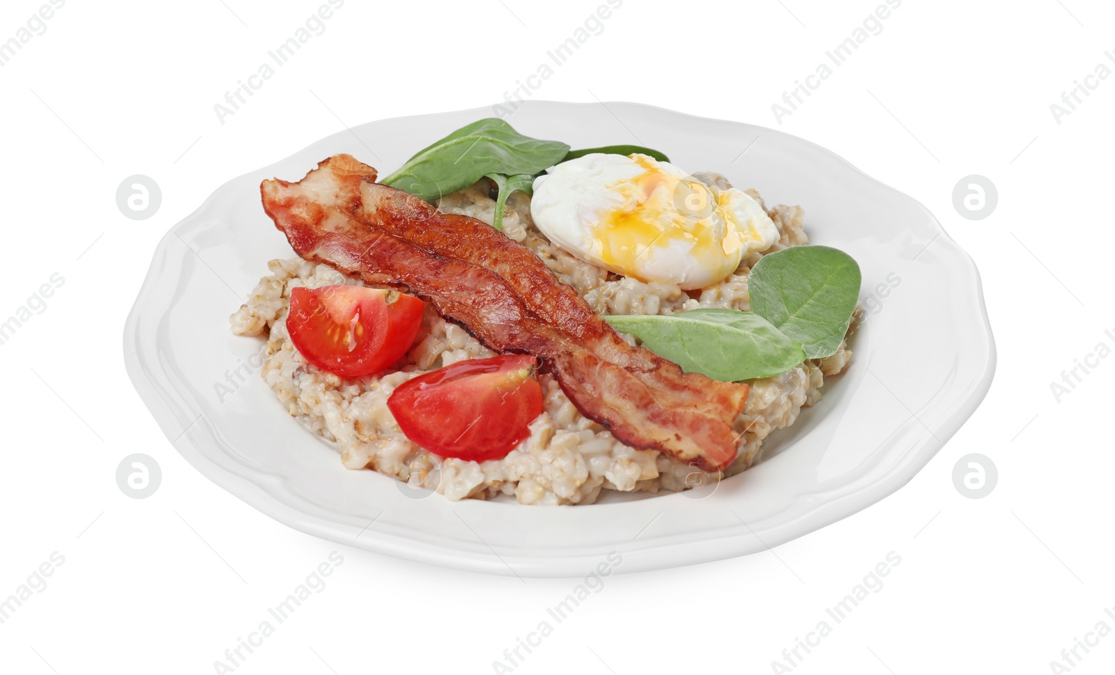 Photo of Delicious boiled oatmeal with poached egg, bacon and tomato isolated on white