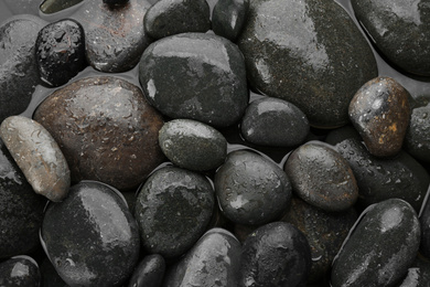 Photo of Spa stones in water as background, top view. Zen lifestyle