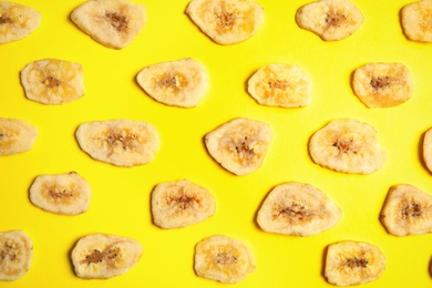 Photo of Flat lay composition with banana slices on color background. Dried fruit as healthy snack