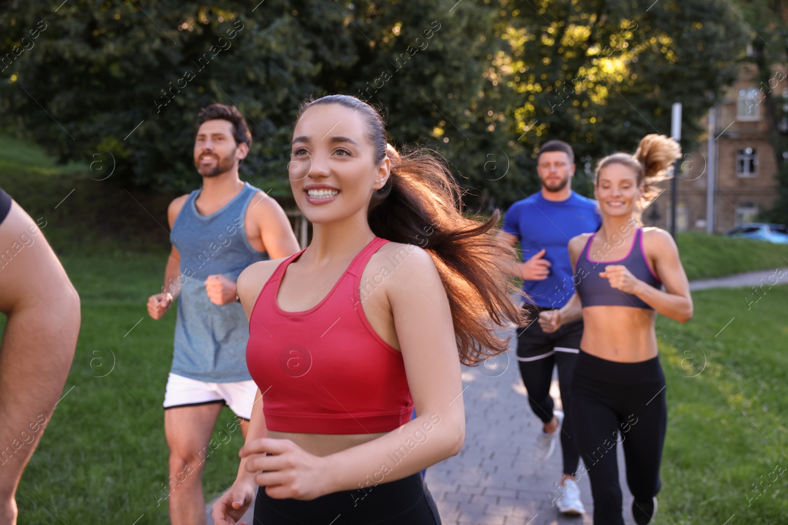 Photo of Group of people running in park. Active lifestyle