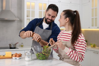 Photo of Happy lovely couple cooking together in kitchen