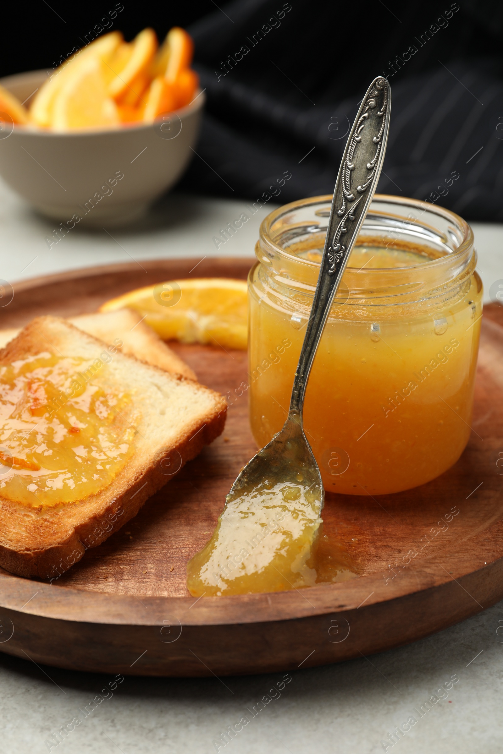 Photo of Delicious toasts with orange marmalade on table, closeup