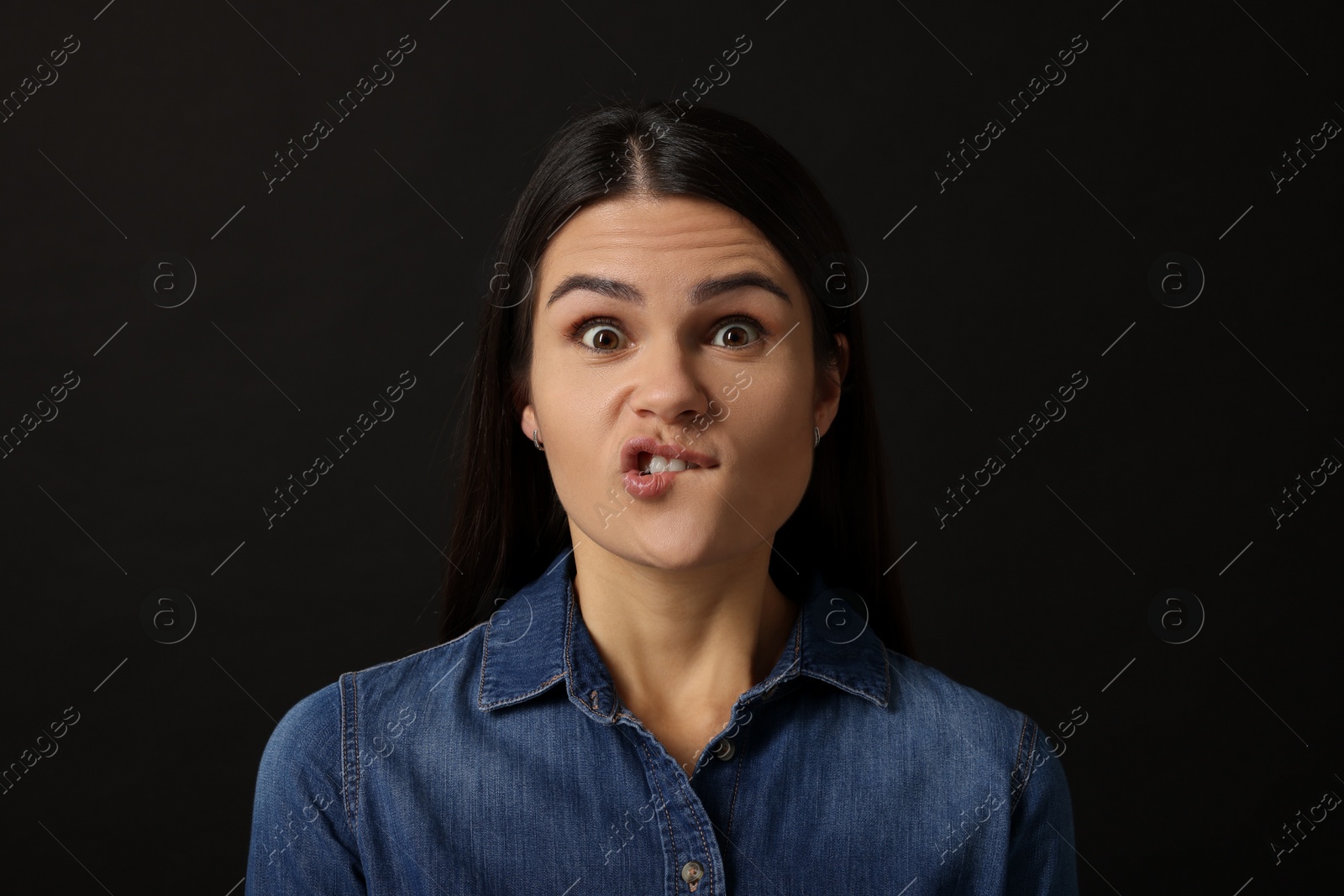 Photo of Personality concept. Emotional woman on black background