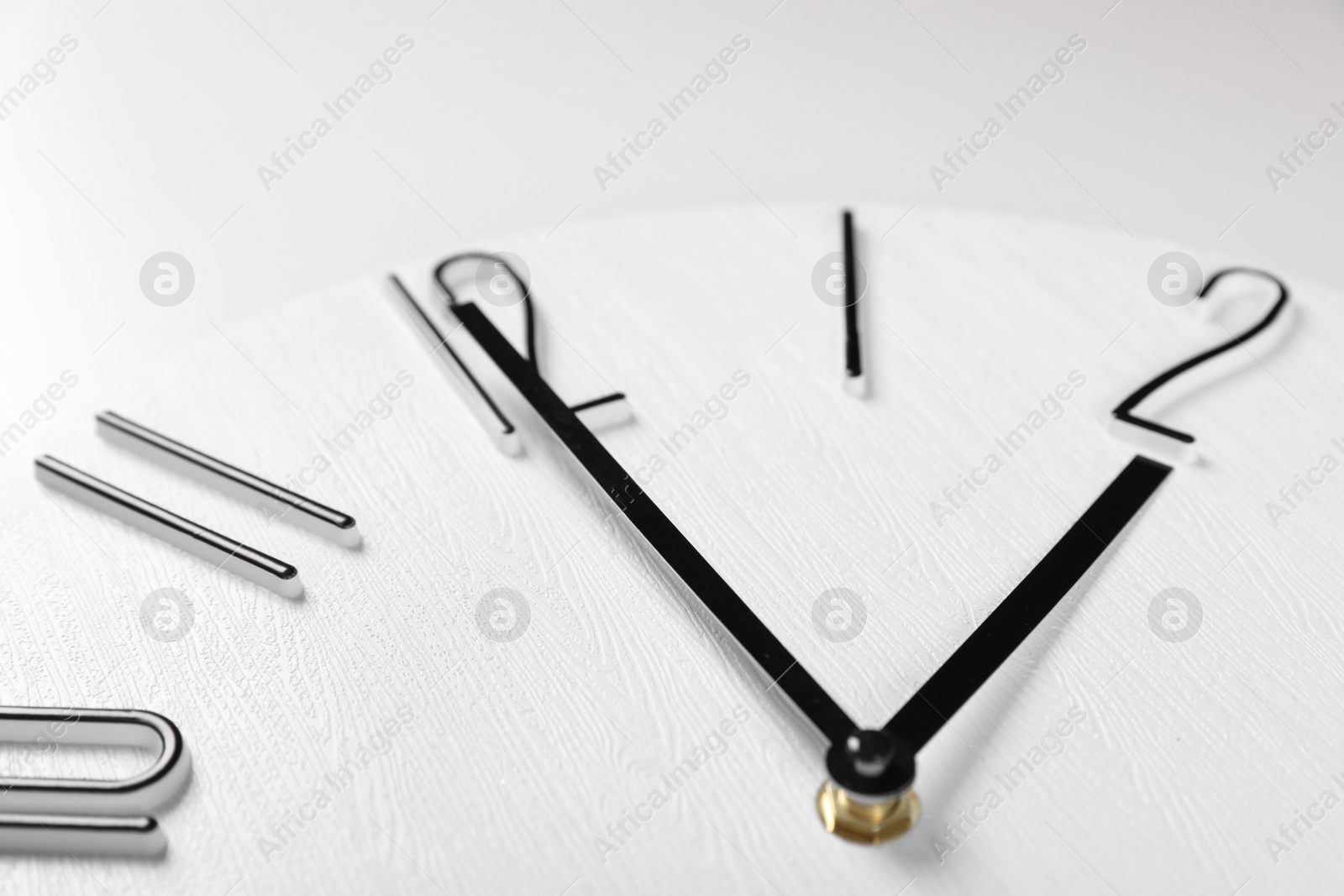 Photo of Stylish analog clock on white background, closeup