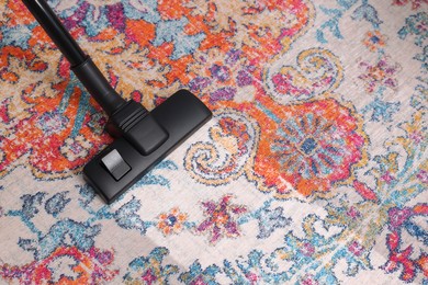 Hoovering carpet with vacuum cleaner, above view and space for text. Clean trace on dirty surface