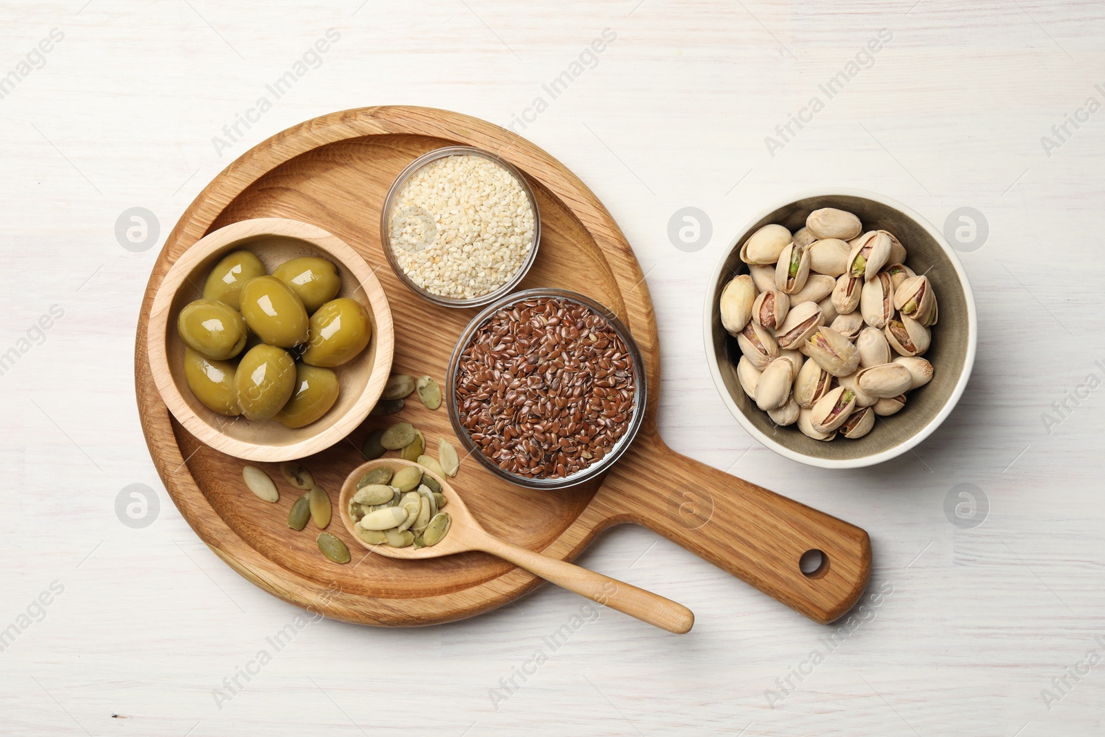 Photo of Different products high in vegetable fats on white wooden table, flat lay