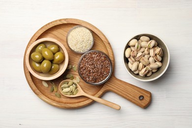 Photo of Different products high in vegetable fats on white wooden table, flat lay