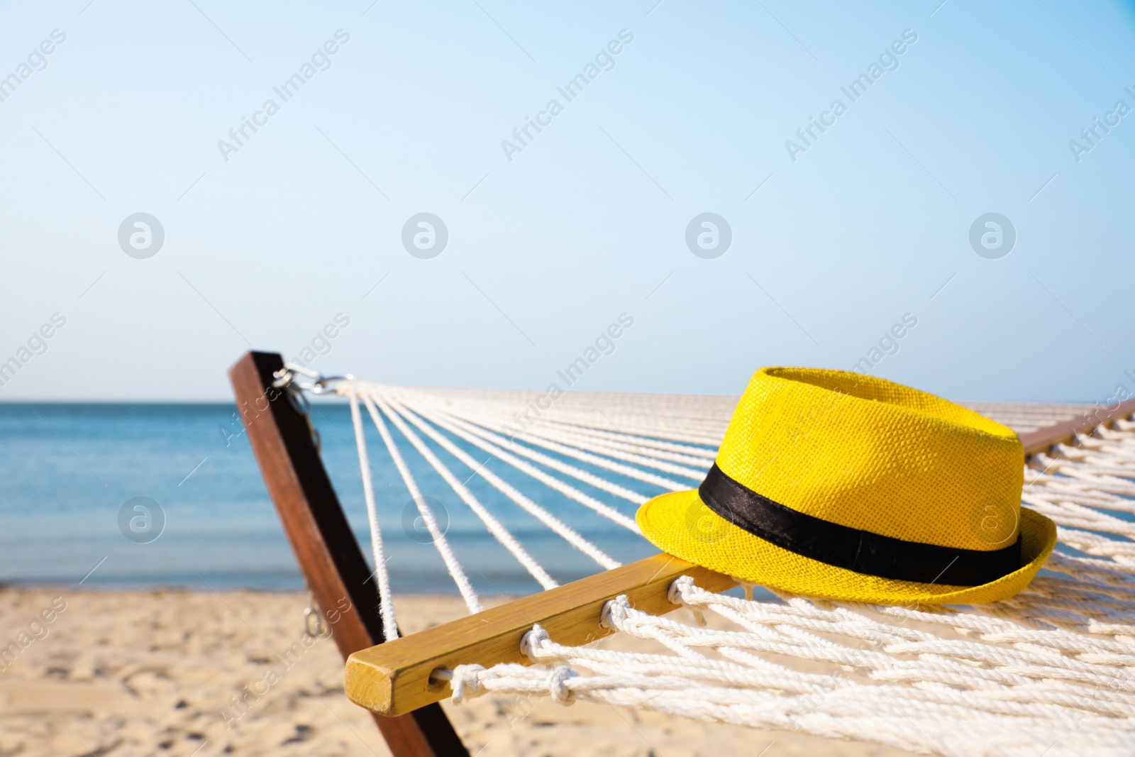 Photo of Hammock and hat at seaside. Time to relax