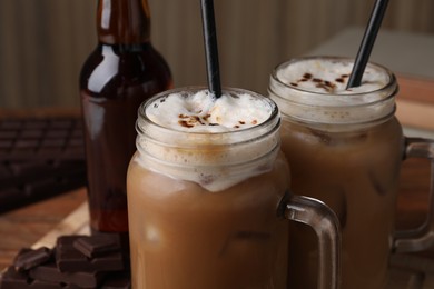Photo of Delicious iced coffee with chocolate syrup, closeup