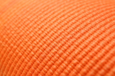 Photo of Orange foam rubber mat as background, closeup view