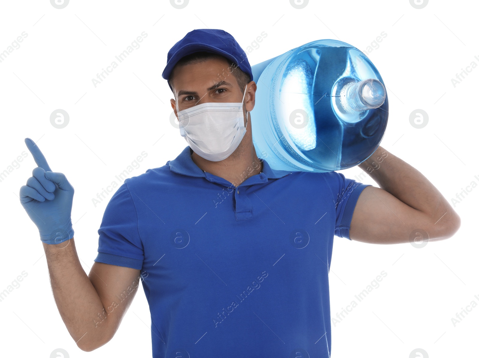 Photo of Courier in medical mask holding bottle for water cooler on white background. Delivery during coronavirus quarantine