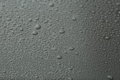 Many water drops on grey background, closeup