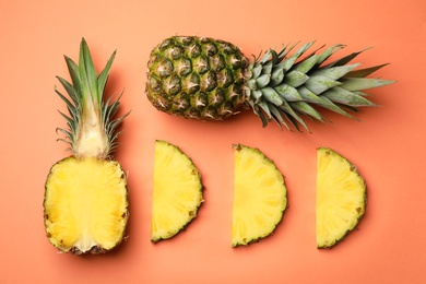 Photo of Flat lay composition with cut and fresh juicy pineapples on color background