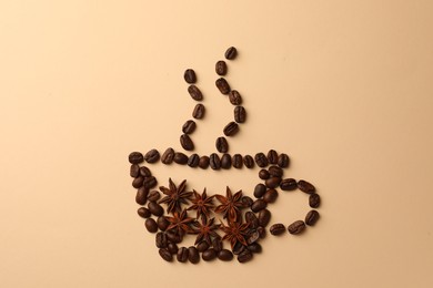 Photo of Cup made with coffee beans and anise stars on beige background, flat lay