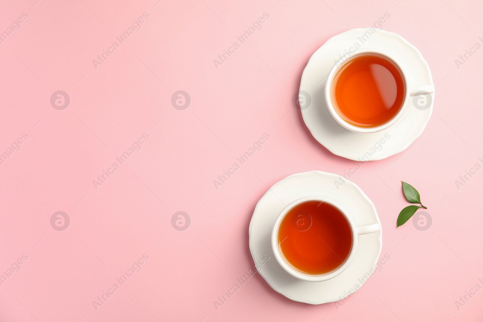 Photo of Flat lay composition with delicious tea and green leaves on color background