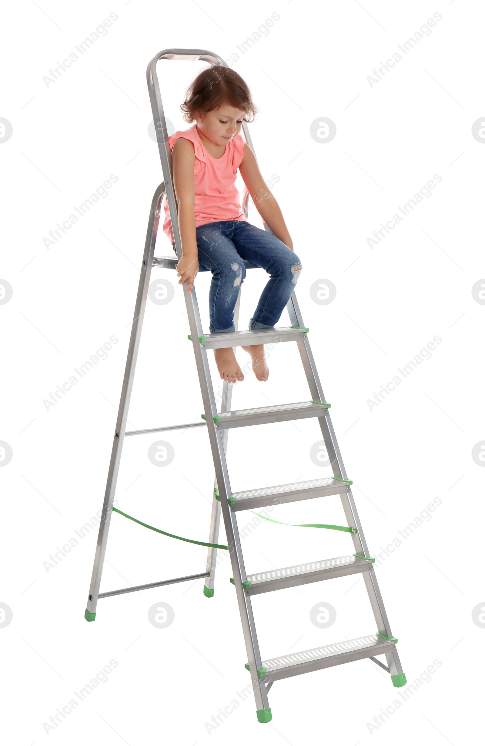 Photo of Little girl climbing up ladder on white background. Danger at home