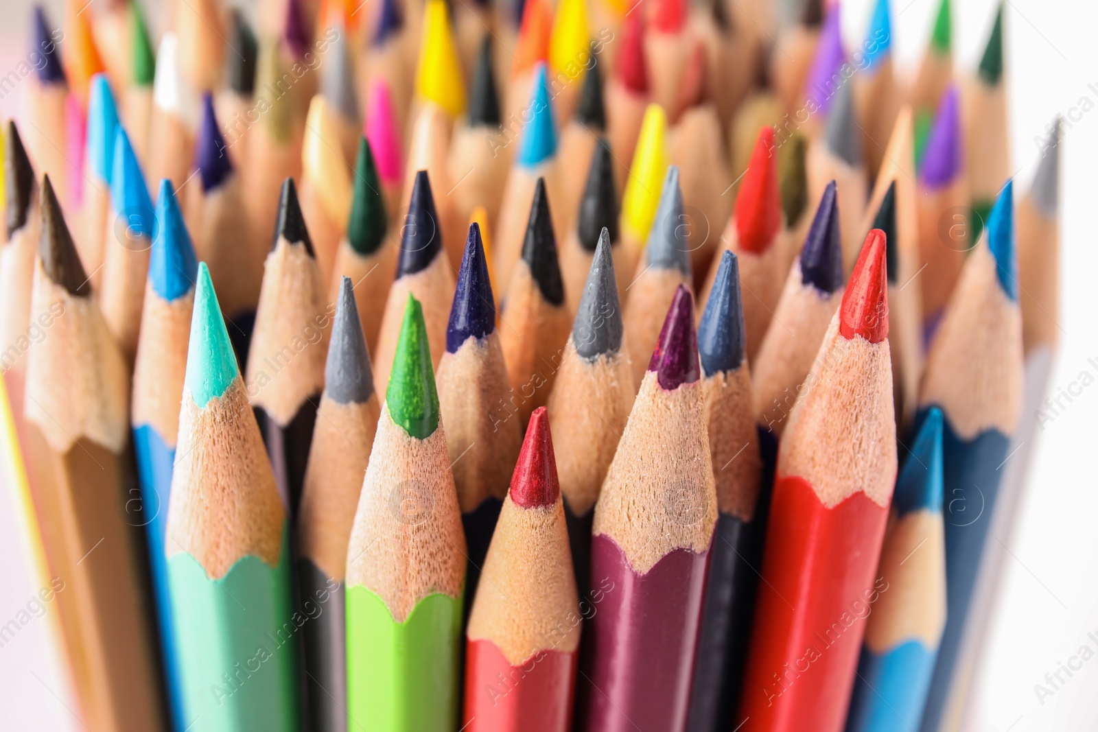 Photo of Different color pencils on white background, closeup view