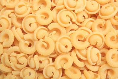 Photo of Raw dischi volanti pasta as background, top view