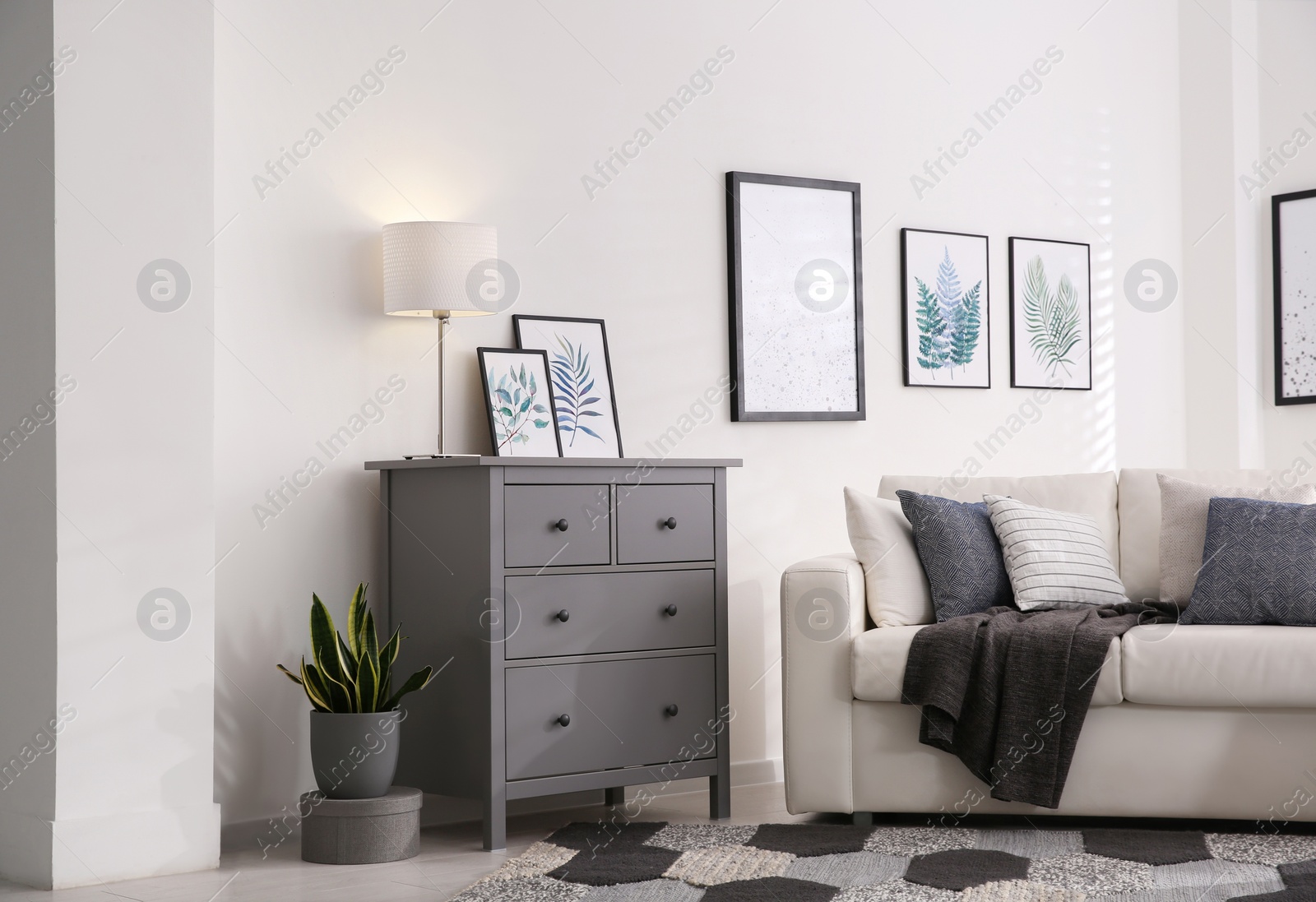 Photo of Modern room interior with grey chest of drawers