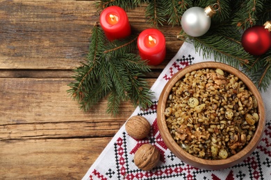 Photo of Traditional Christmas slavic dish kutia served on wooden table, flat lay