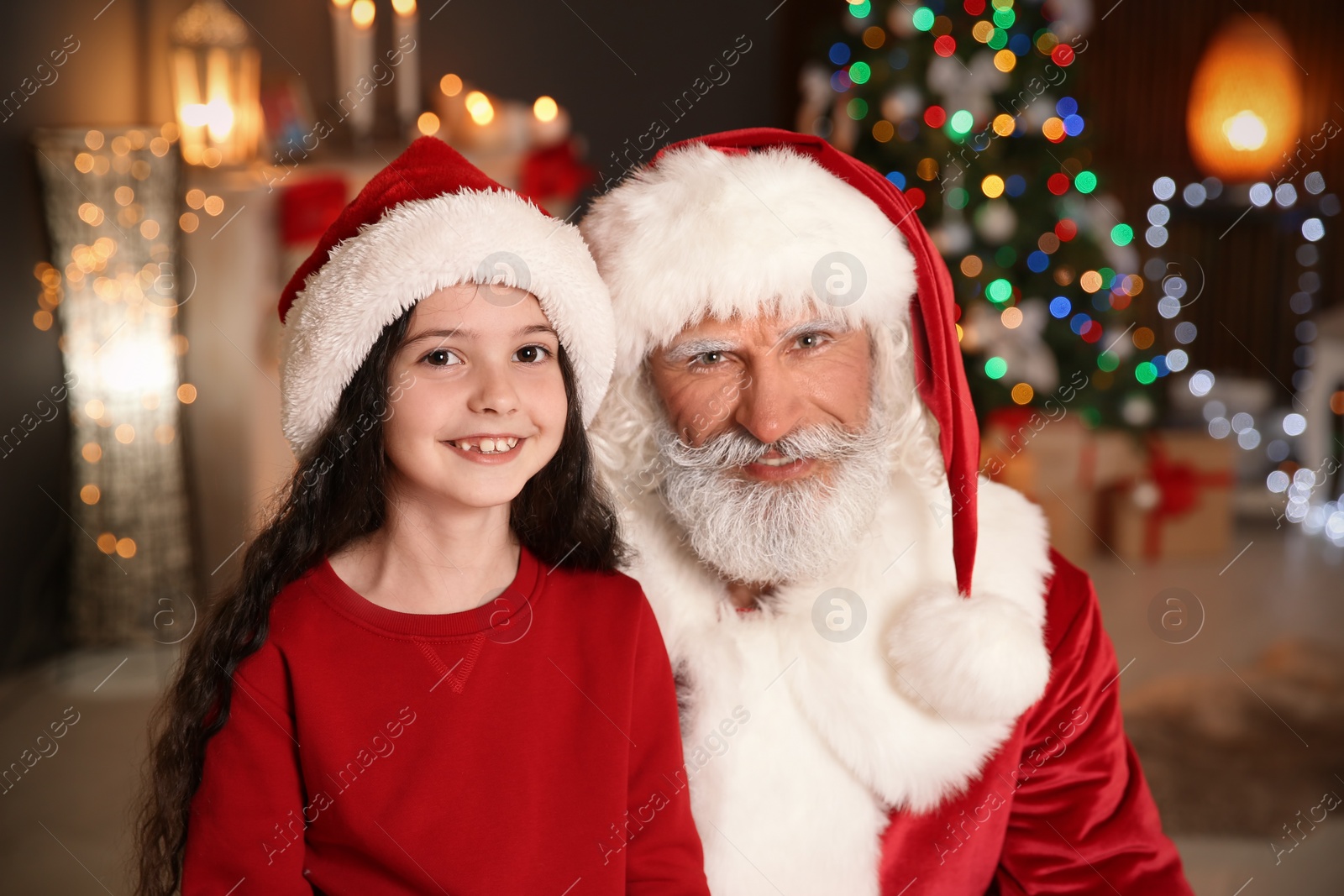 Photo of Portrait of little child with Santa Claus at home. Christmas celebration